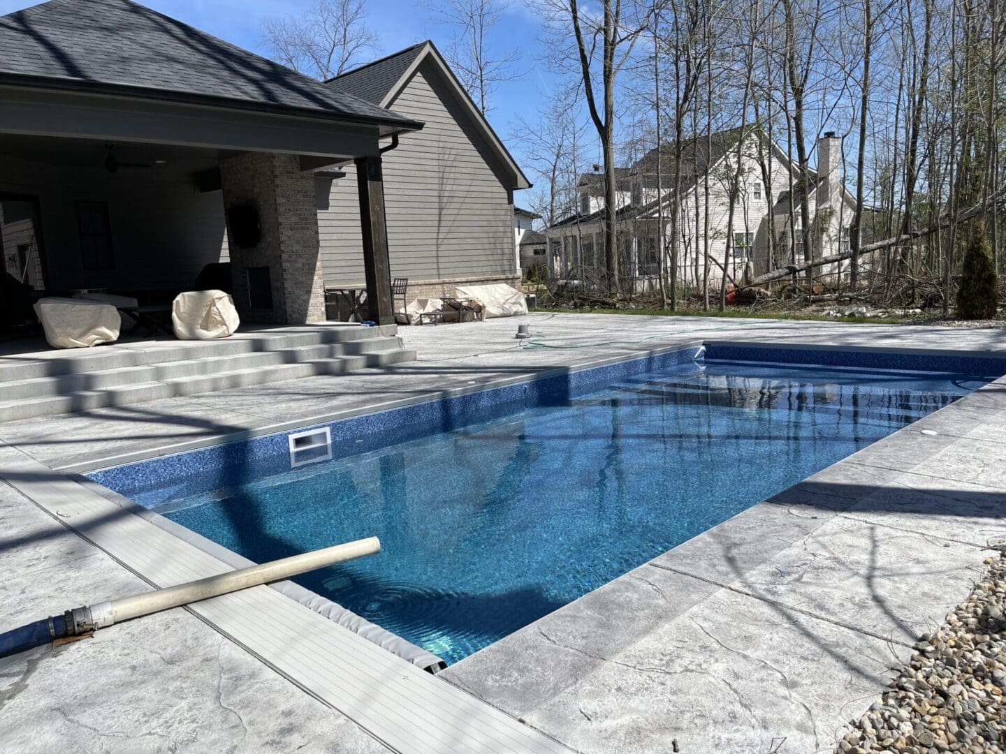 A pool that is in the middle of some kind of yard.