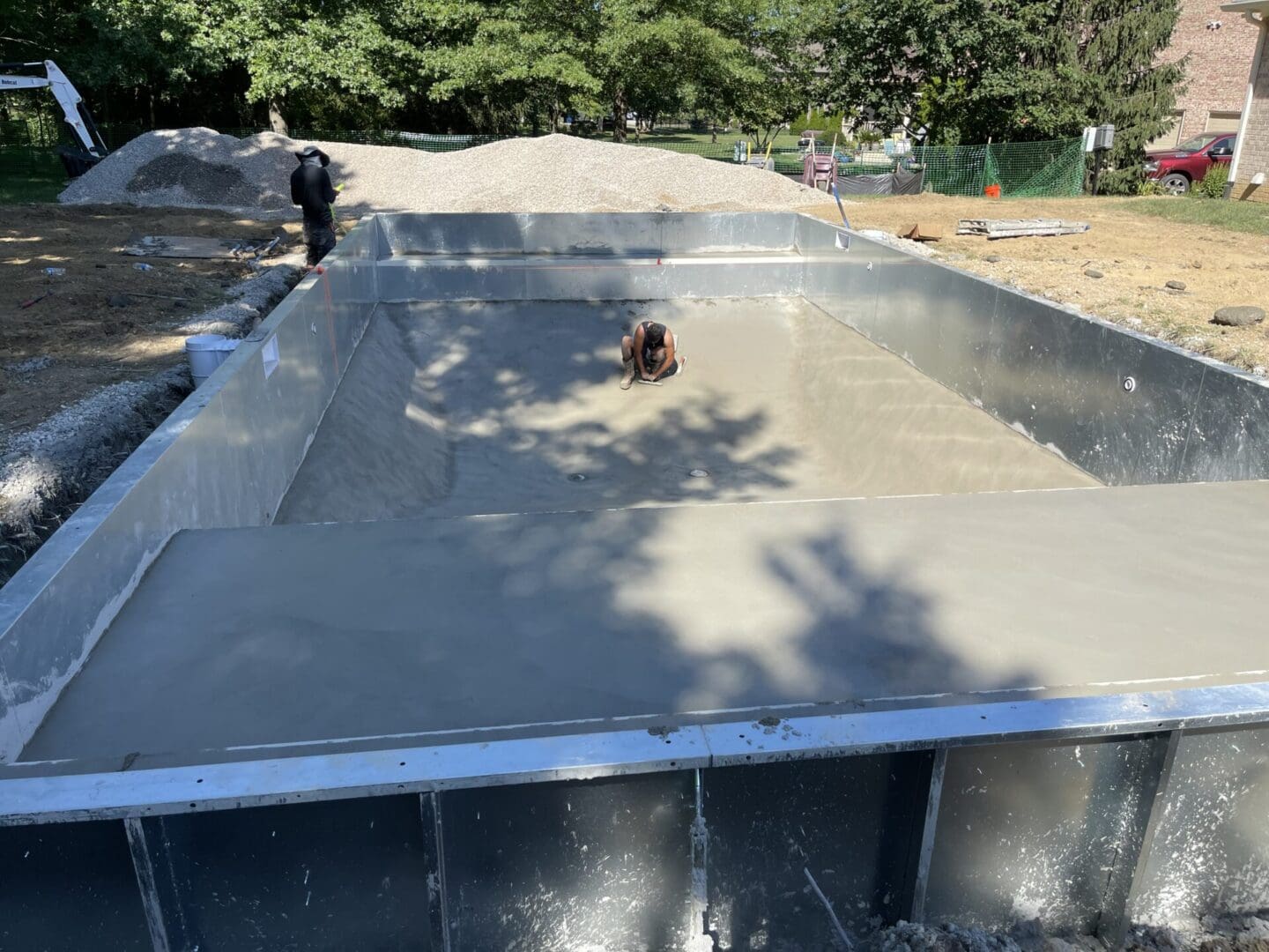 A person riding on the back of a skateboard in a pool.