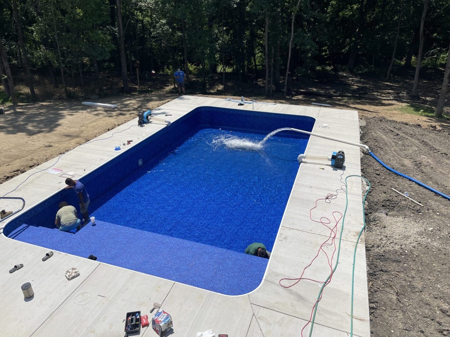 A pool being built in the middle of a field.