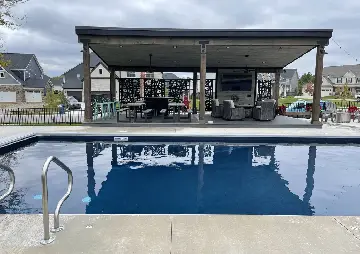 A pool with an open air bar and covered patio.